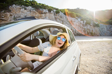 Young woman drive and having fun in cabrio against mountains copy space and empty place for text - travel and summer voyage nature concept