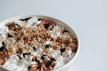 Chocolate and peanut ice cream on a white background, top view