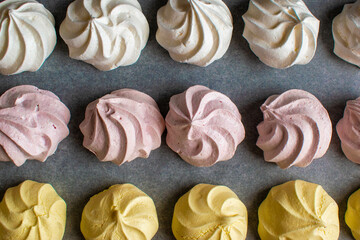 Sweet airy meringue, on a dark background. Home Cooking Concept