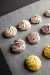 Sweet airy meringue, on a dark background. Home Cooking Concept