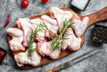 raw chicken wings on stone background