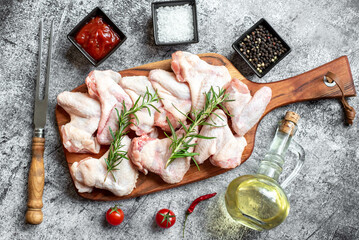 raw chicken wings on stone background