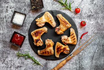 grilled chicken wings on stone background 