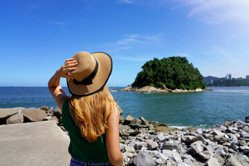 Traveler girl looking the uninhabited Urubuqueçaba Island near Santos coast, Baixada Santista,...