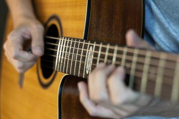Fototapeta premium Close up of guitarist playing a acoustic guitar