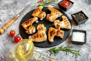 grilled chicken wings on stone background 