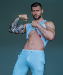 Sexy and naked muscular young man sensual posing. Sexy shirtless male model. Attractive young naked...