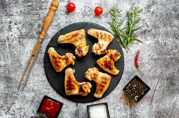 grilled chicken wings on stone background 