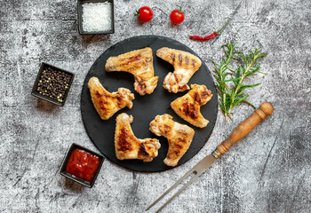 grilled chicken wings on stone background 