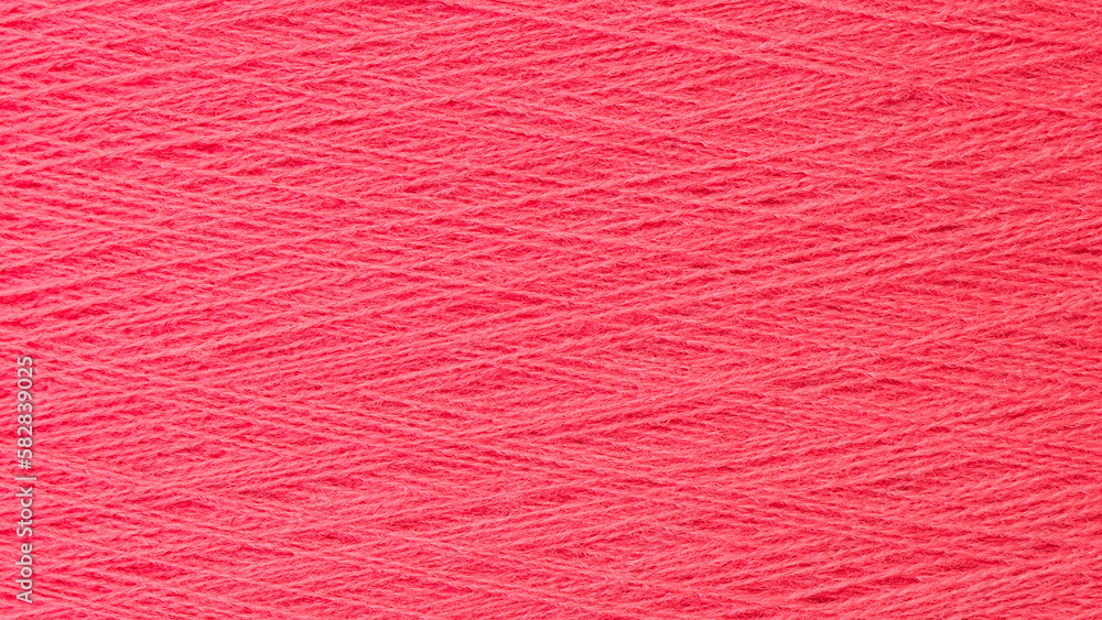 Aufkleber close up texture picture of sew thread spool red color, macro background