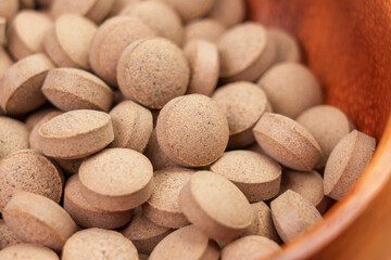 Fototapeta na wymiar Brewer's yeast pills. Dietary supplement tablets