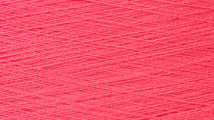 Close up texture picture of sew thread spool red color, macro background