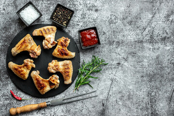 grilled chicken wings on stone background with copy space for your text
