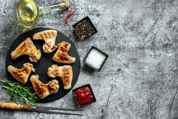 grilled chicken wings on stone background with copy space for your text
