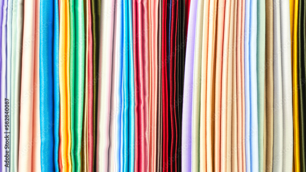 Aufkleber mix colorful hanging vertical stripe textile, fabrics, cloths on the rack. texture of multicolored f