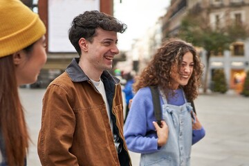 A group of excited friends from different cultures laughing and enjoying their arrival in Madrid on vacation.