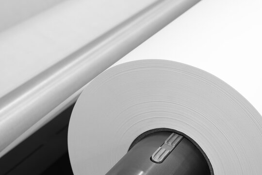 Rolls paper and fabric in wide industrial plotter