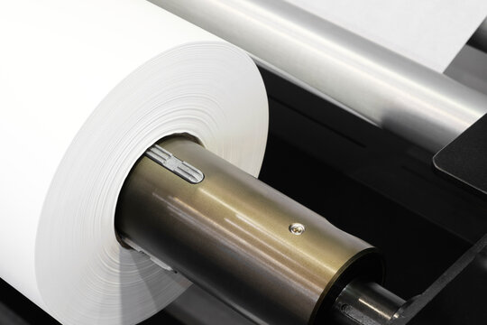 Rolls paper and fabric in wide industrial plotter