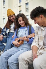 Joyful friends enjoy ukulele tunes