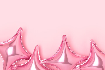 Frame made of air star balloons on a pink background. Festive composition with place for text.