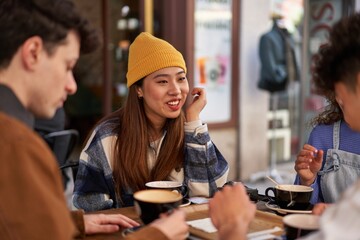 Friends from different cultures enjoy coffee and tea together.