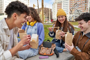 Friends from diverse cultures enjoy noodles and laughter.