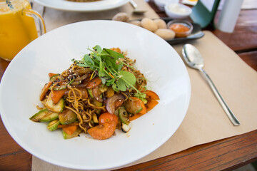 Plate with vegan asian food. Wok noodles with vegetables