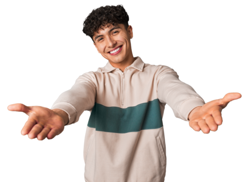 Young latin man pointing with finger at you as if inviting come closer.