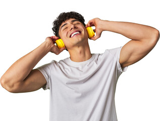 A young man enjoys his favorite tunes in high-quality sound, using wireless headphones for a...