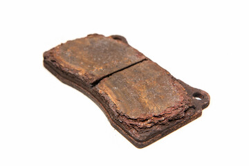 The old used and rusty disc brake pads isolated in a white background.
