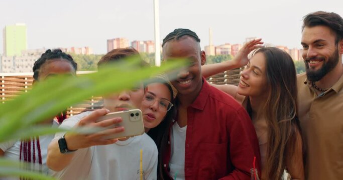 Multiethnic group of young American, Asian Caucasian peopleis taking selfie, making video call with drinks looking at camera laughing having fun.slow motion friedship lifestyle free spare time