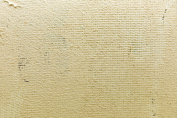 plastering a new modern house wall with plastic grid on a PVC insulation basis