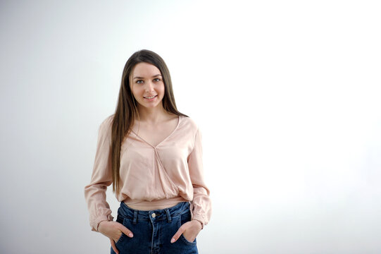 woman holding hands in pockets of blue jeans looking straight smiling advertising product product conference communication online learning clothing shop fitting room there is space for text young girl - Powered by Adobe