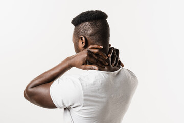 African man feel spine and neck pain because of spinal nerves compression on white background....