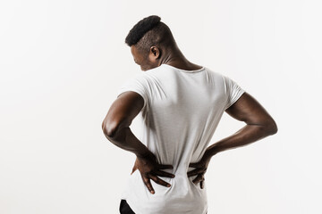 Obraz na płótnie Canvas African american man feel backache spine pain because of UTI pyelonephritis disease on white background. Kidney infection pyelonephritis urinary tract infection.