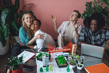 International group of students working on modern urban architecture project with renewable green energy source, alternative electricity, waste recycling. Excited and happy to win ecology contest