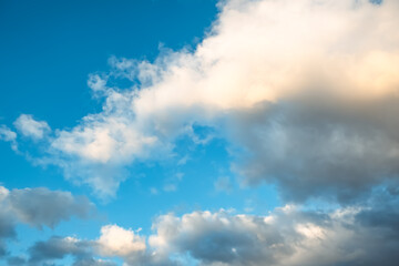 Naklejka na ściany i meble Blue sky with white cumulus clouds moving fast in day light. Cloudscape. Nature background. Windy weather forecast. Religion concept. Heaven landscape. Fresh air. Morning inspiration. Daylight