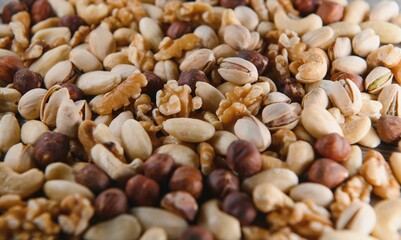 Background of various nuts almond, cashew, hazelnut, pistachio, walnut. Vegetarian meal. Healthy eating concept
