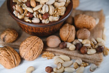 Mixed nuts on a plate. White background
