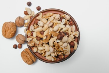 Mixed nuts on a plate. White background