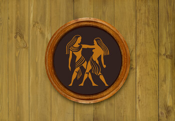 The sign of the zodiac Gemini in a round frame on the wall of the boards