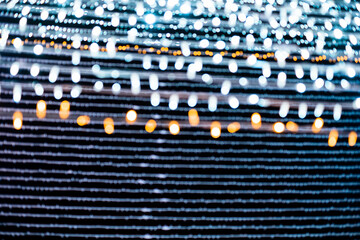 Abstract lights. Christmas street lights with straight lines shape, out of focus.  White and gold...