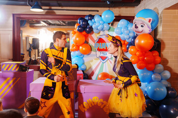 man and woman actors play at a children's party. 