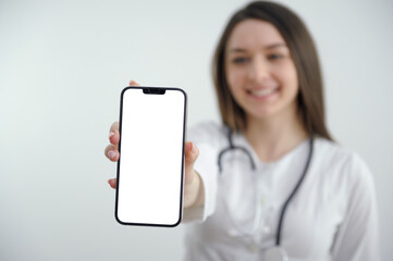 Portrait Of Happy Young Female Doctor Showing Cellphone. High quality photo
