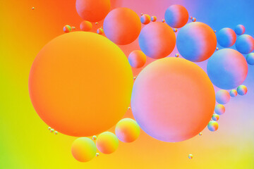 Abstract macro background with oil and water bubbles in happy summer colours.