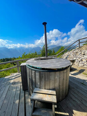 Wooden hot tub on terrace by the cottage with a wonderful view of mountains
