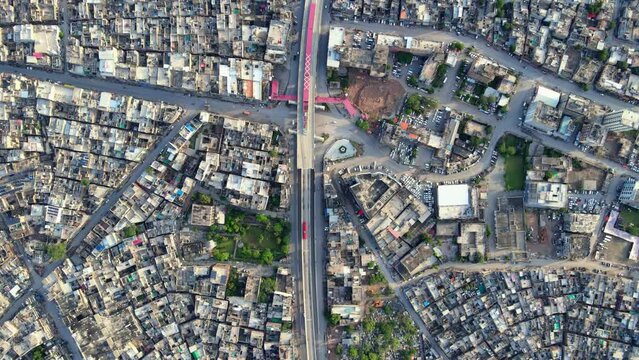 Aerial wide shot overlooking dense population around Metro Bus Service Muree Road Rawalpindi City In Pakistan. Aerial Overlooking shot of Twin Cities of Pakistan