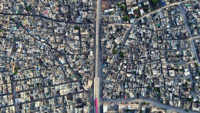 Aerial Wide Pan-up Shot of dense population around Muree road Rawalpindi City In Pakistan with Margalla Hills Islamabad in vicinity.  Aerial Pan Up Shot of Twin Cities of Pakistan