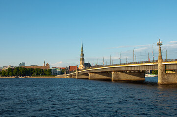 Fototapeta premium Riga. in the photo, the panorama of the city of Riga, the river in the foreground, the blue sky in the background
