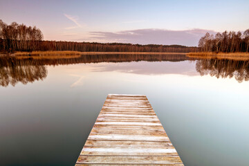 Old wooden footbridge on the lake